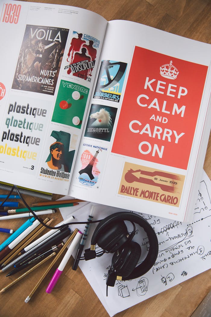 An open magazine featuring graphic designs and motivational quotes in a creative workspace.